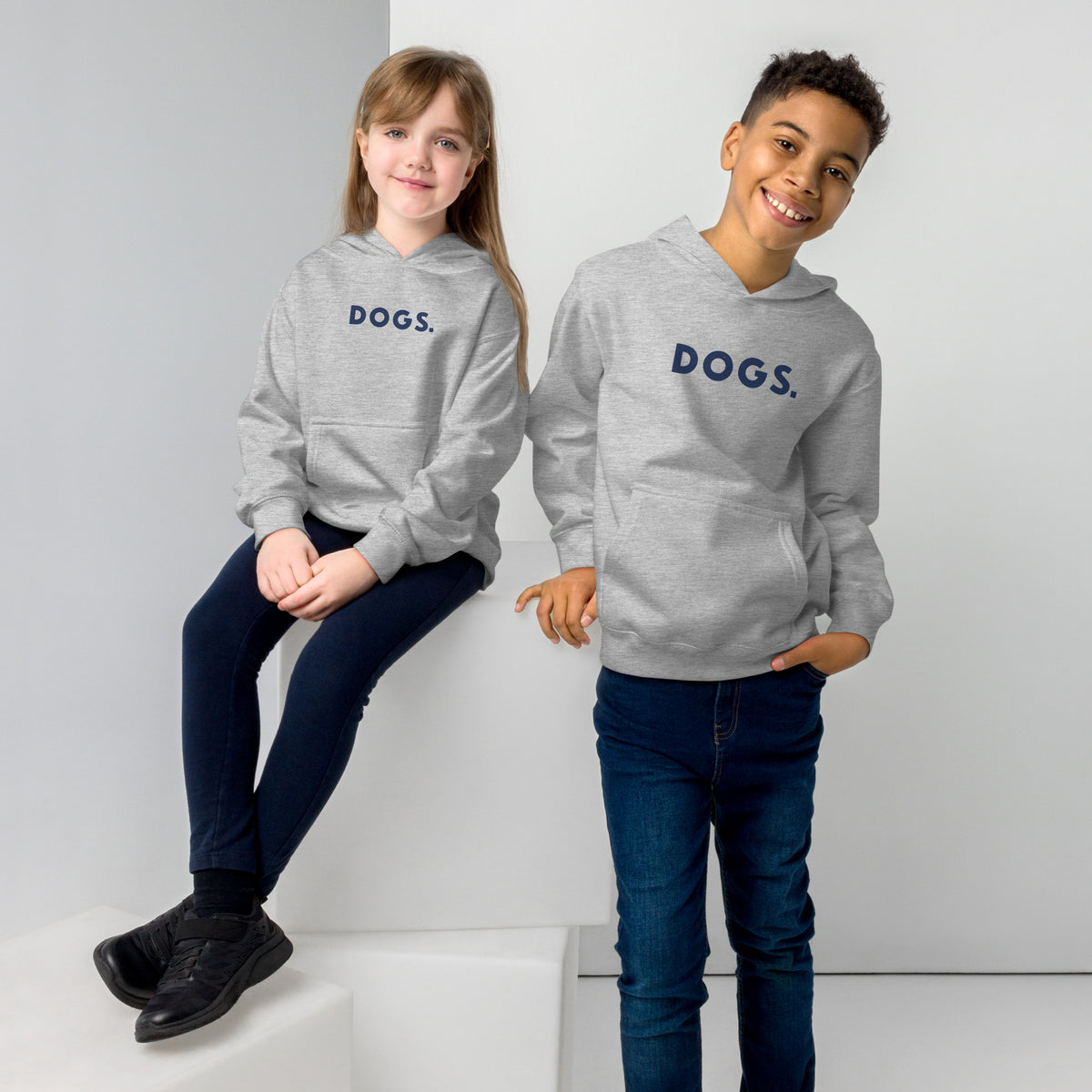 The word "Dogs." with a full stop, in vintage print styling, printed on a SodaPop Cool kids hoodie.