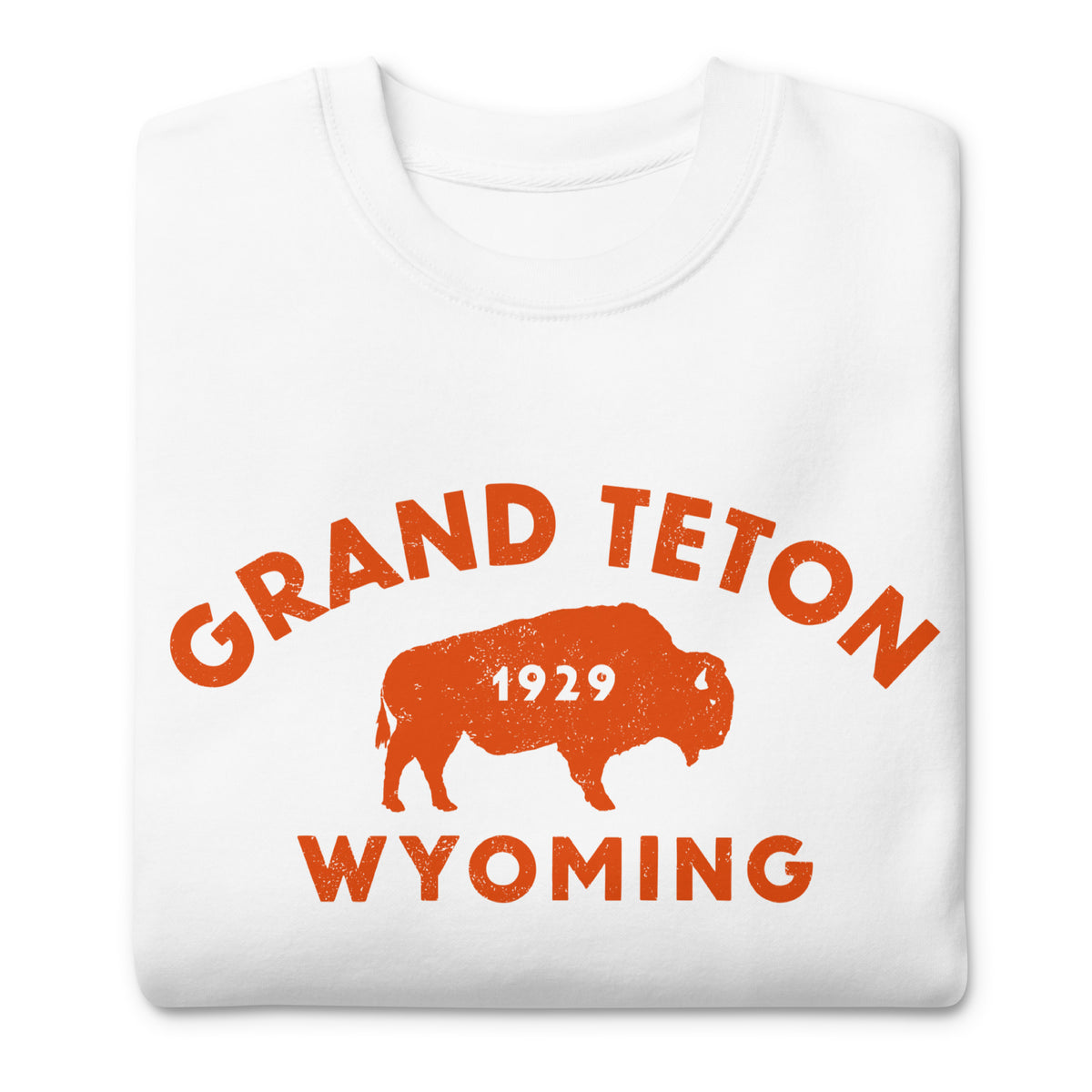 Bison in front of Grand Teton rock formations, vintage national park poster styling, printed on a SodaPop Cool crew sweatshirt.