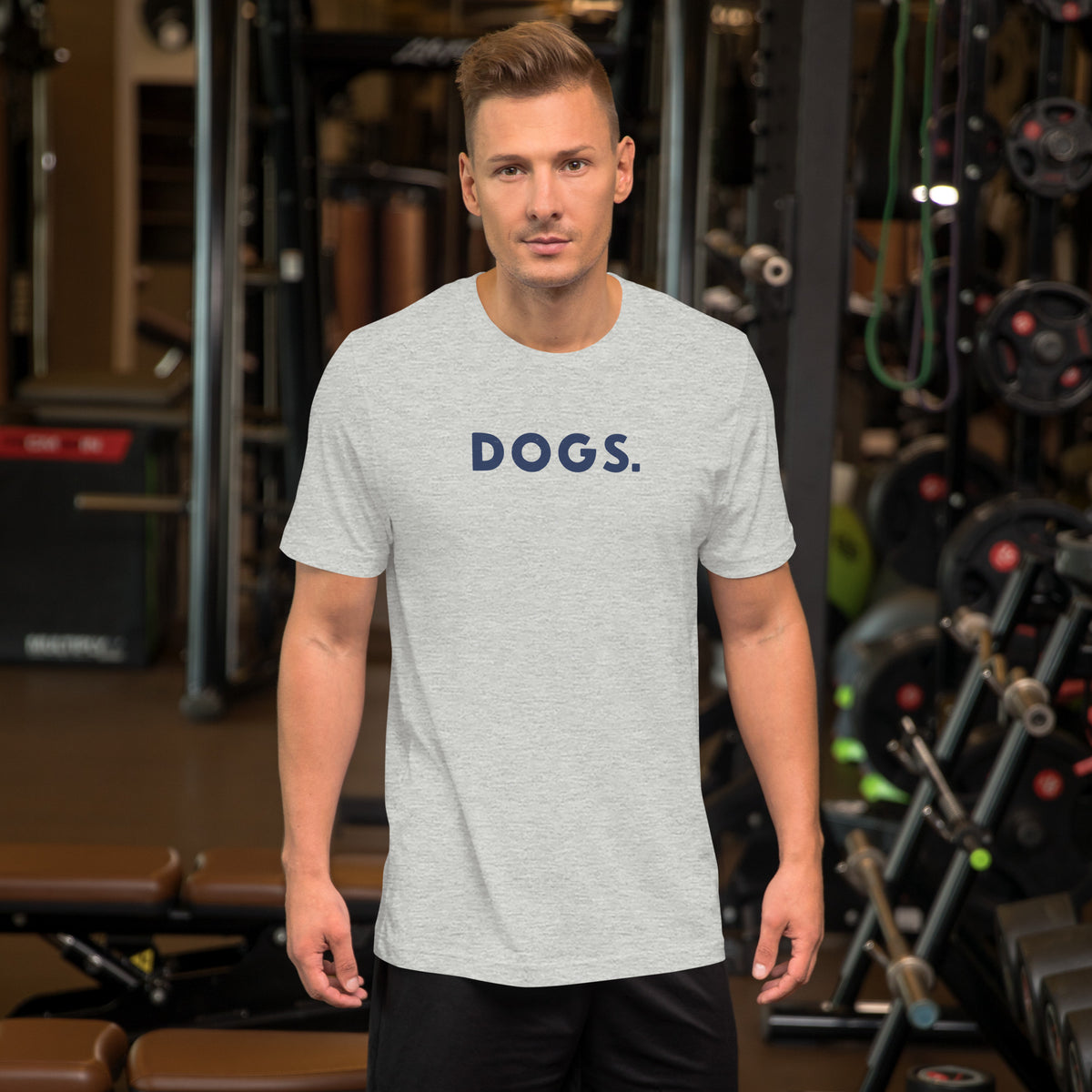 The word "Dogs." with a full stop, in vintage print styling, printed on a SodaPop Cool t-shirt.