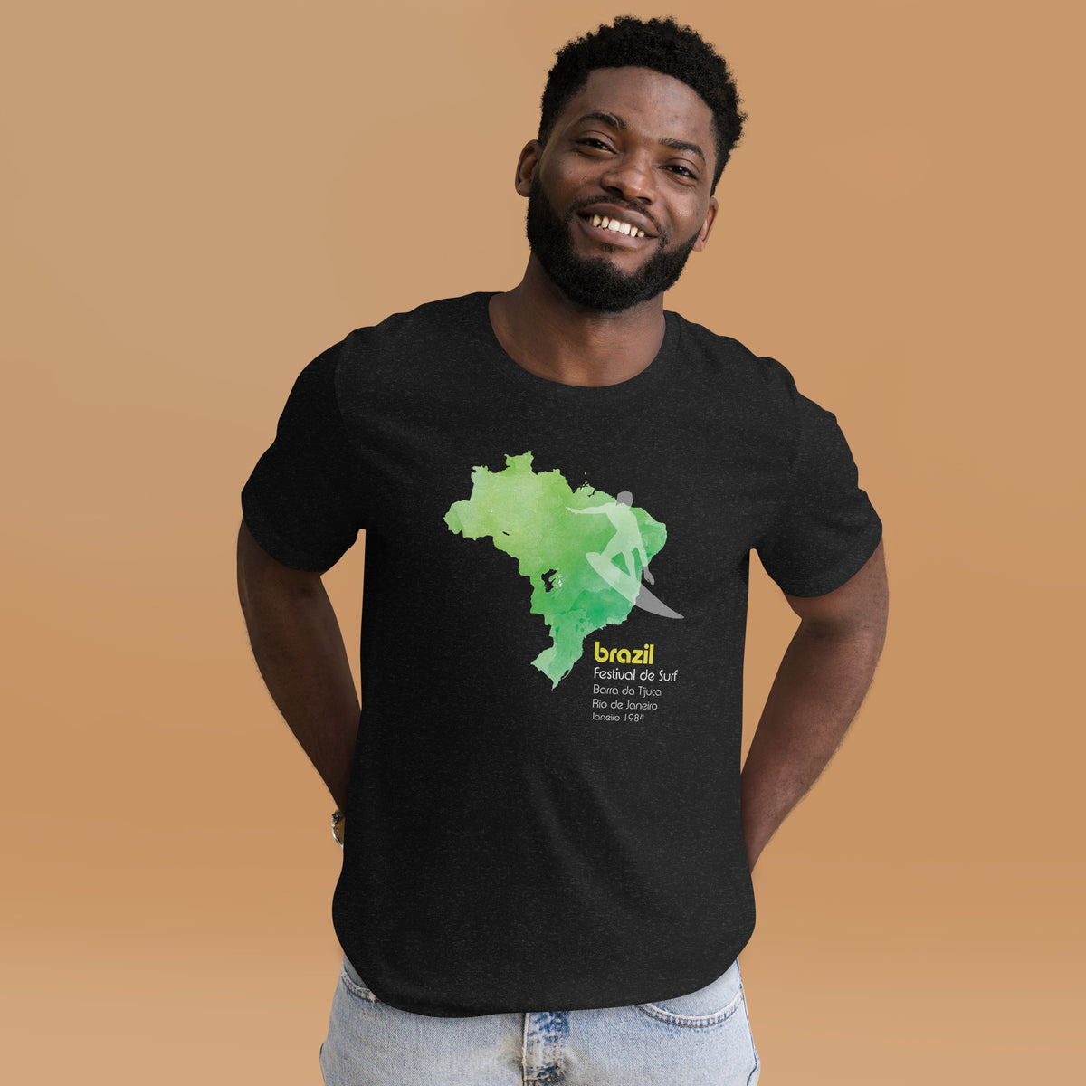 Brazil country outline with a surfer figure and "1984", vintage surf festival poster styling, printed on a SodaPop Cool t-shirt.