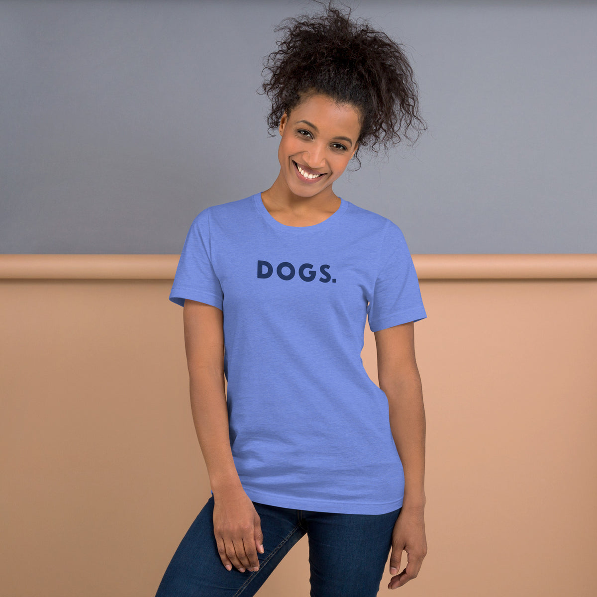 The word "Dogs." with a full stop, in vintage print styling, printed on a SodaPop Cool t-shirt.