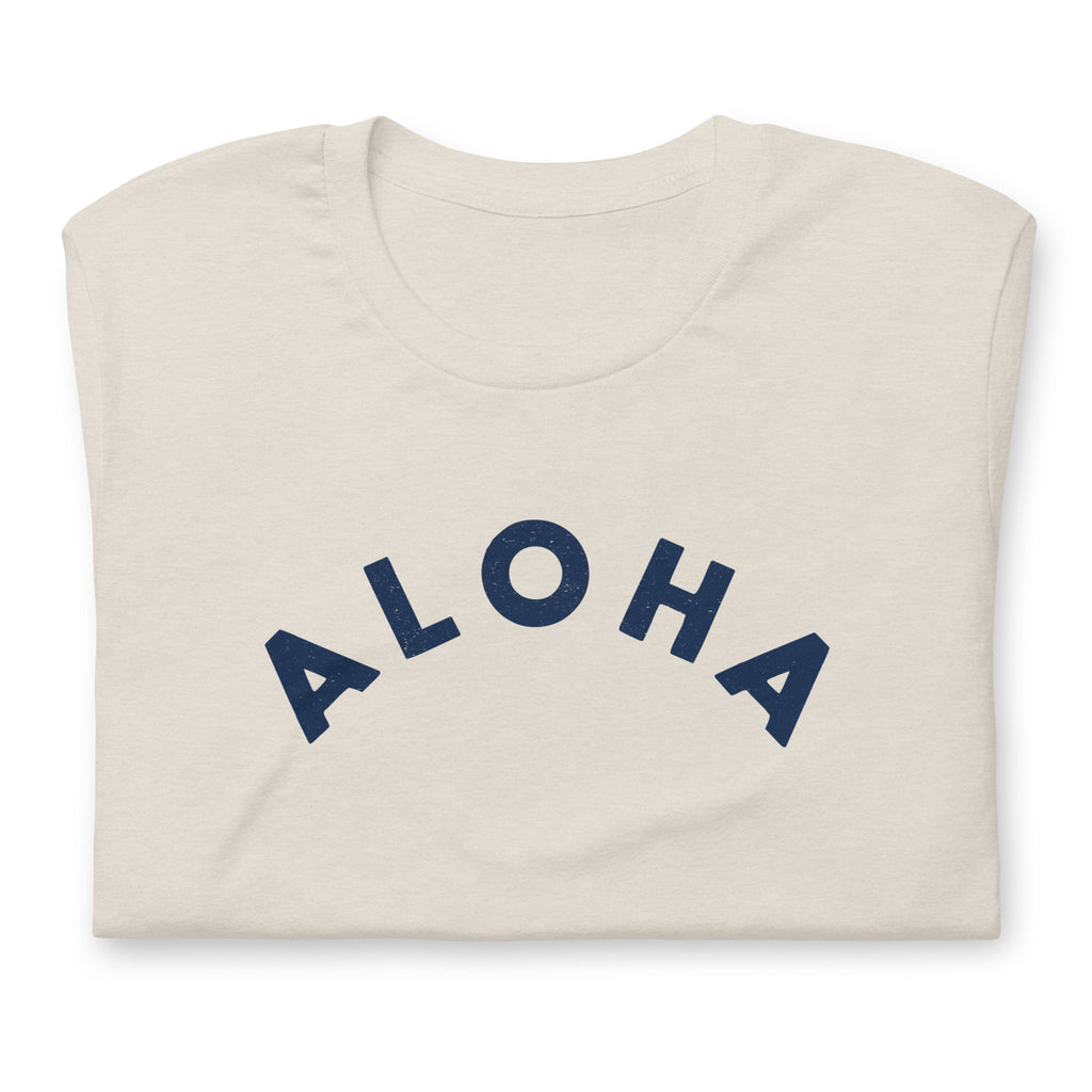 "Aloha" in clean vintage Hawaiian lettering, printed on a SodaPop Cool t-shirt.