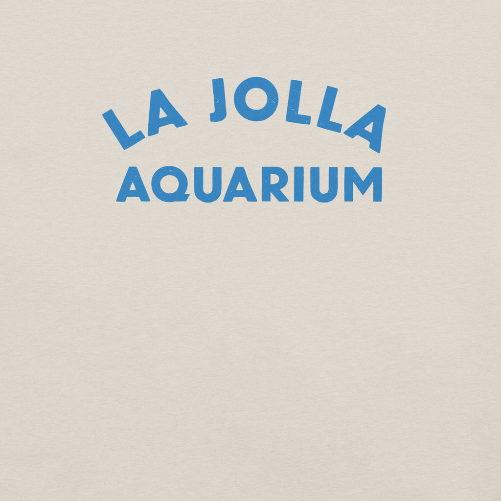 "La Jolla Aquarium" in classic vintage type, printed on a SodaPop Cool t-shirt.