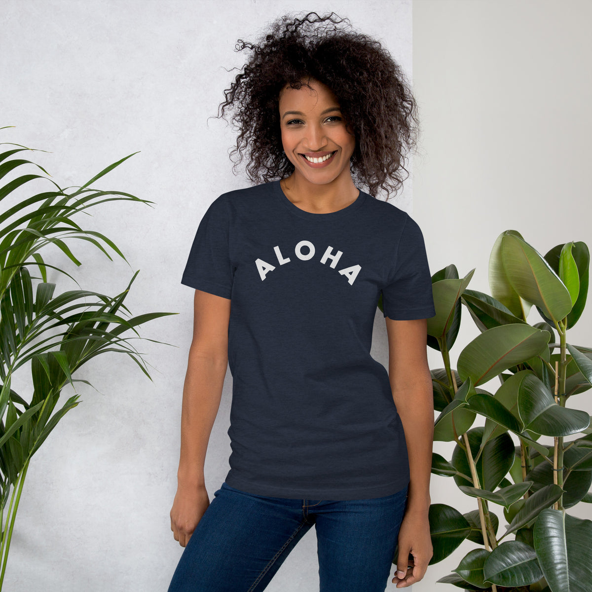 "Aloha" in clean vintage Hawaiian lettering, printed on a SodaPop Cool t-shirt.
