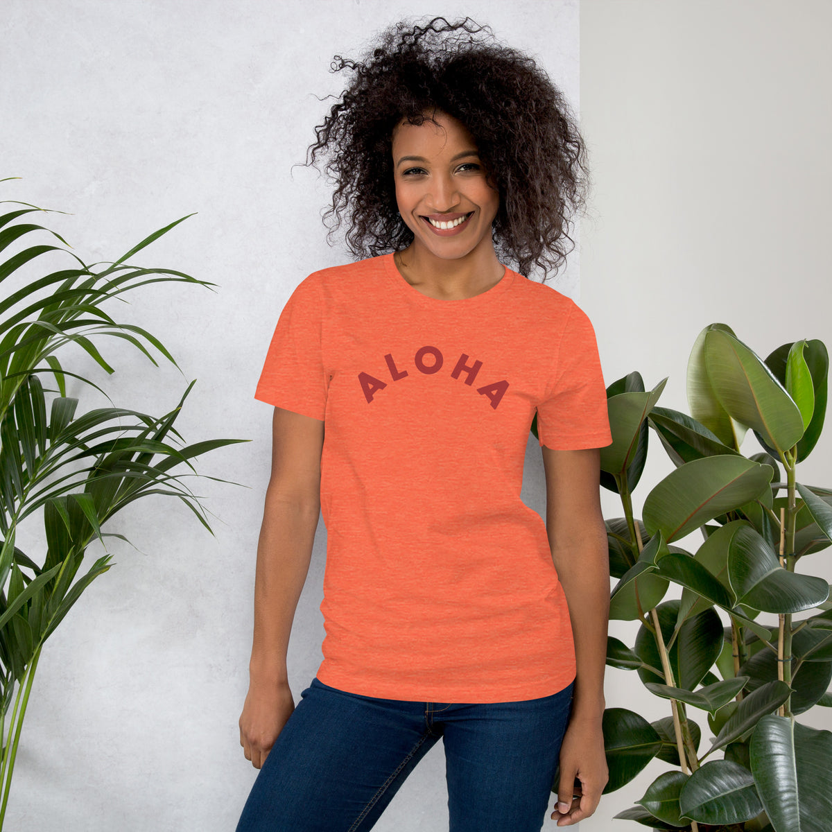 "Aloha" in clean vintage Hawaiian lettering, printed on a SodaPop Cool t-shirt.