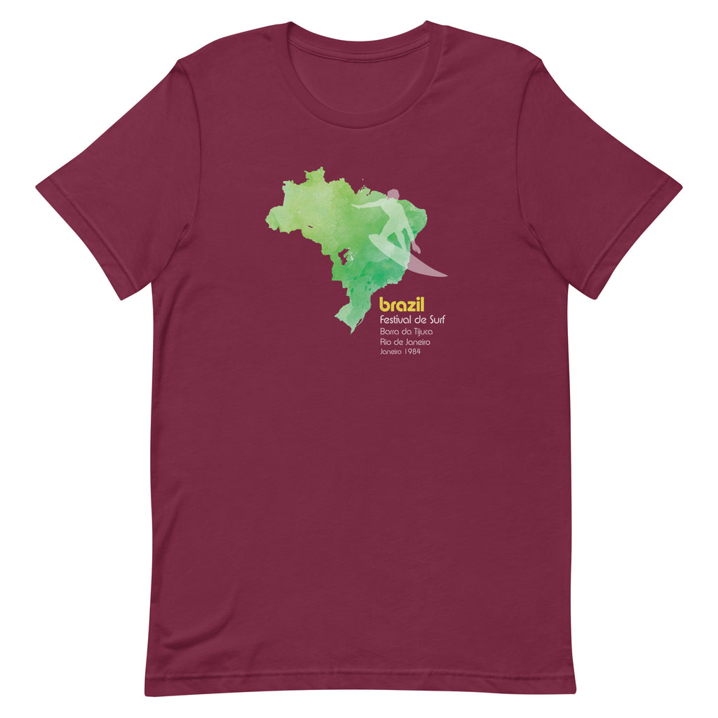 Brazil country outline with a surfer figure and "1984", vintage surf festival poster styling, printed on a SodaPop Cool t-shirt.