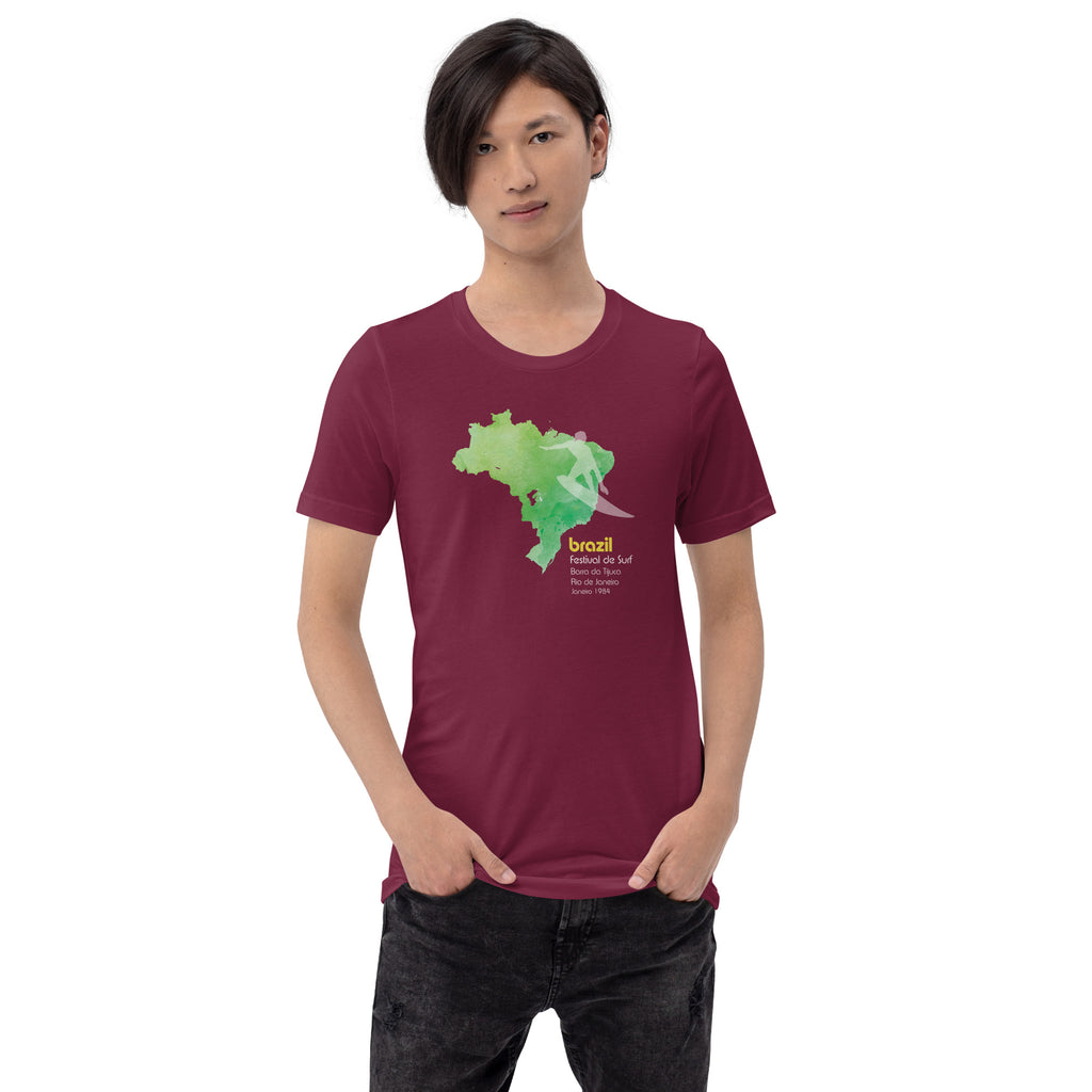 Brazil country outline with a surfer figure and "1984", vintage surf festival poster styling, printed on a SodaPop Cool t-shirt.