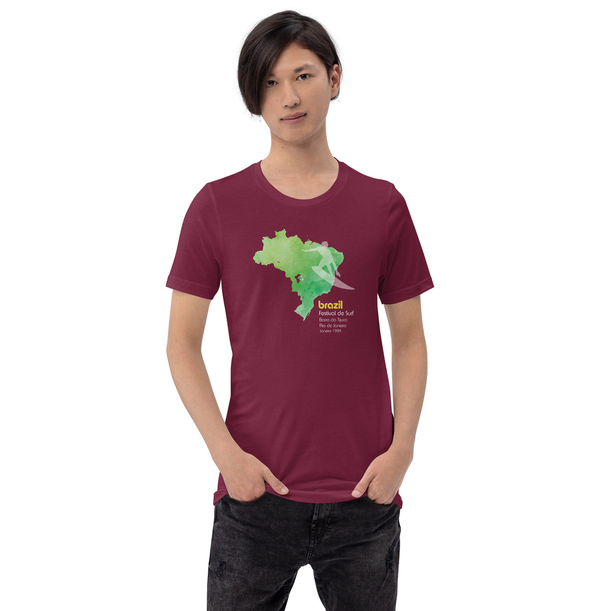 Brazil country outline with a surfer figure and "1984", vintage surf festival poster styling, printed on a SodaPop Cool t-shirt.