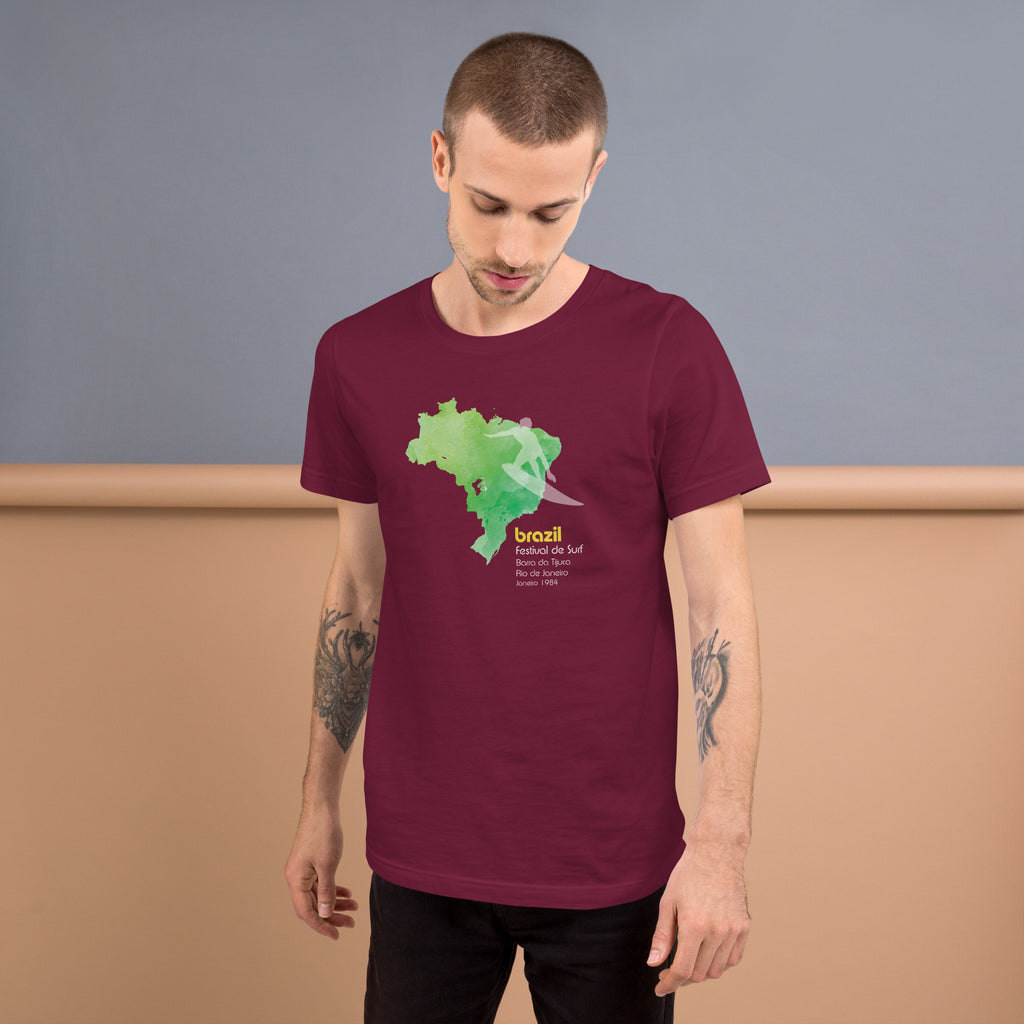 Brazil country outline with a surfer figure and "1984", vintage surf festival poster styling, printed on a SodaPop Cool t-shirt.