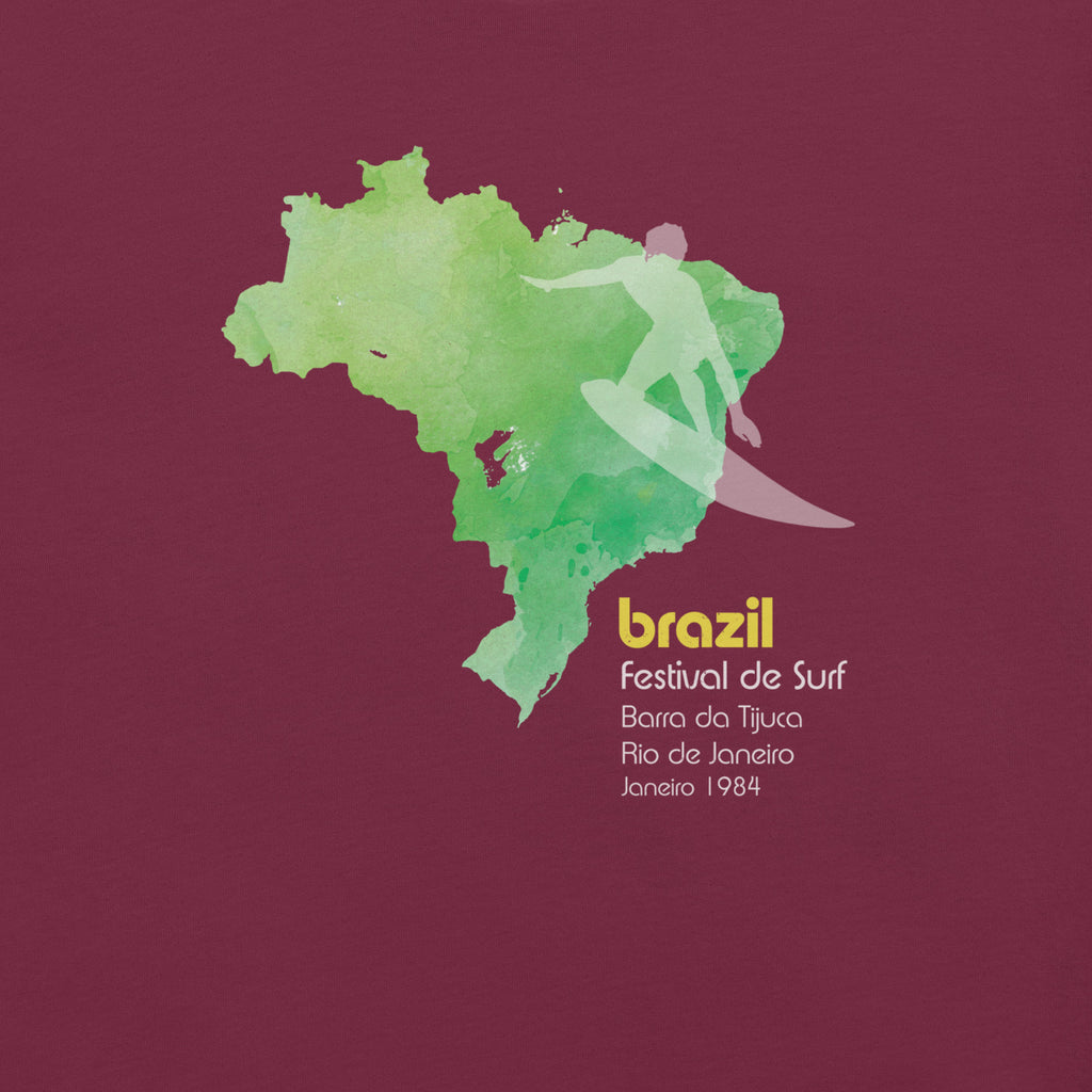 Brazil country outline with a surfer figure and "1984", vintage surf festival poster styling, printed on a SodaPop Cool t-shirt.