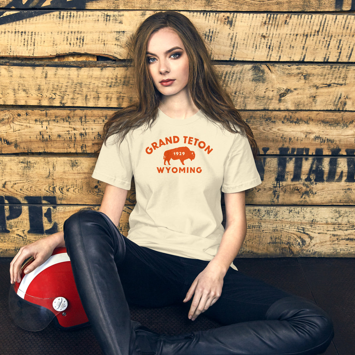 Bison in front of Grand Teton rock formations, vintage national park poster styling, printed on a SodaPop Cool t-shirt.