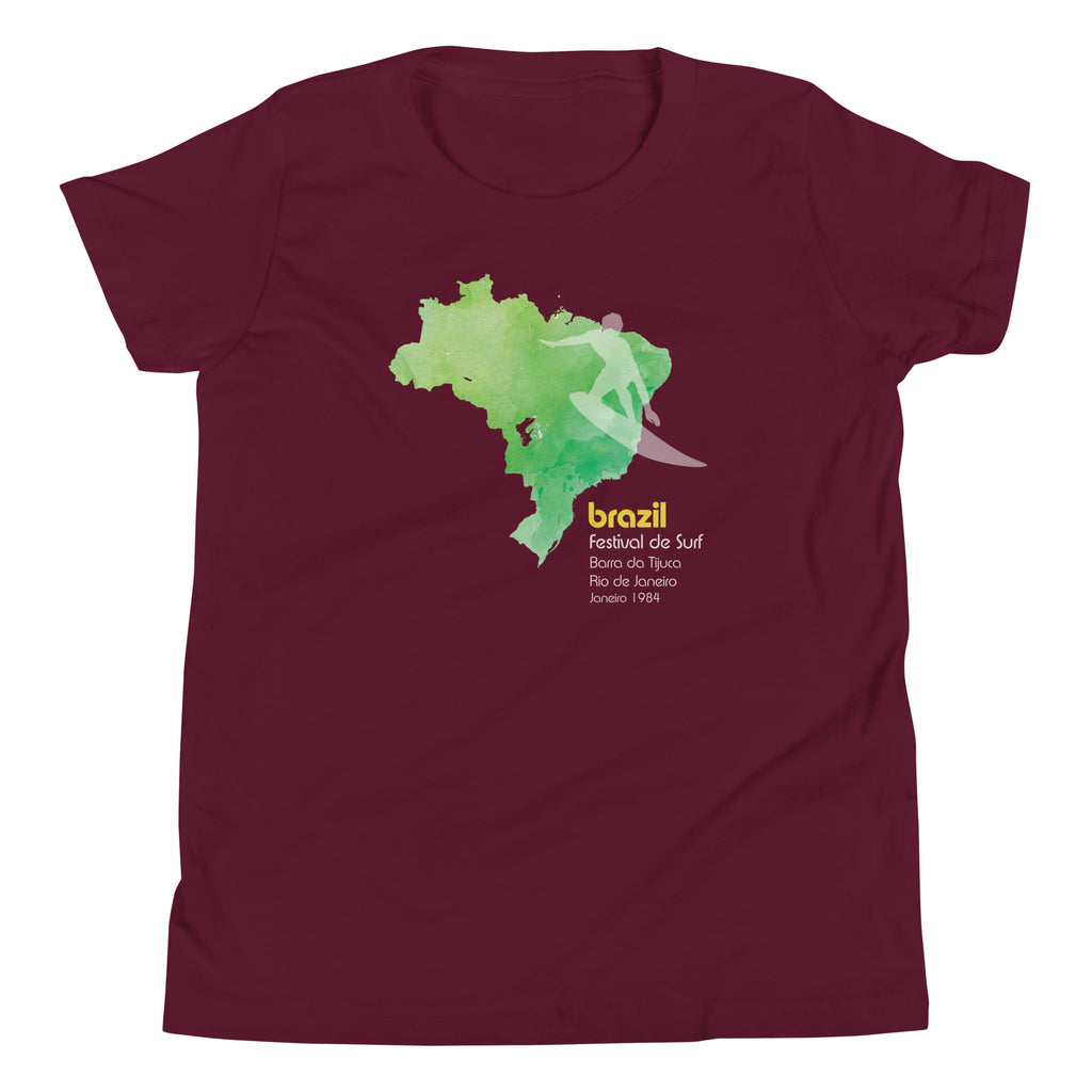 Brazil country outline with a surfer figure and "1984", vintage surf festival poster styling, printed on a SodaPop Cool kids t-shirt.
