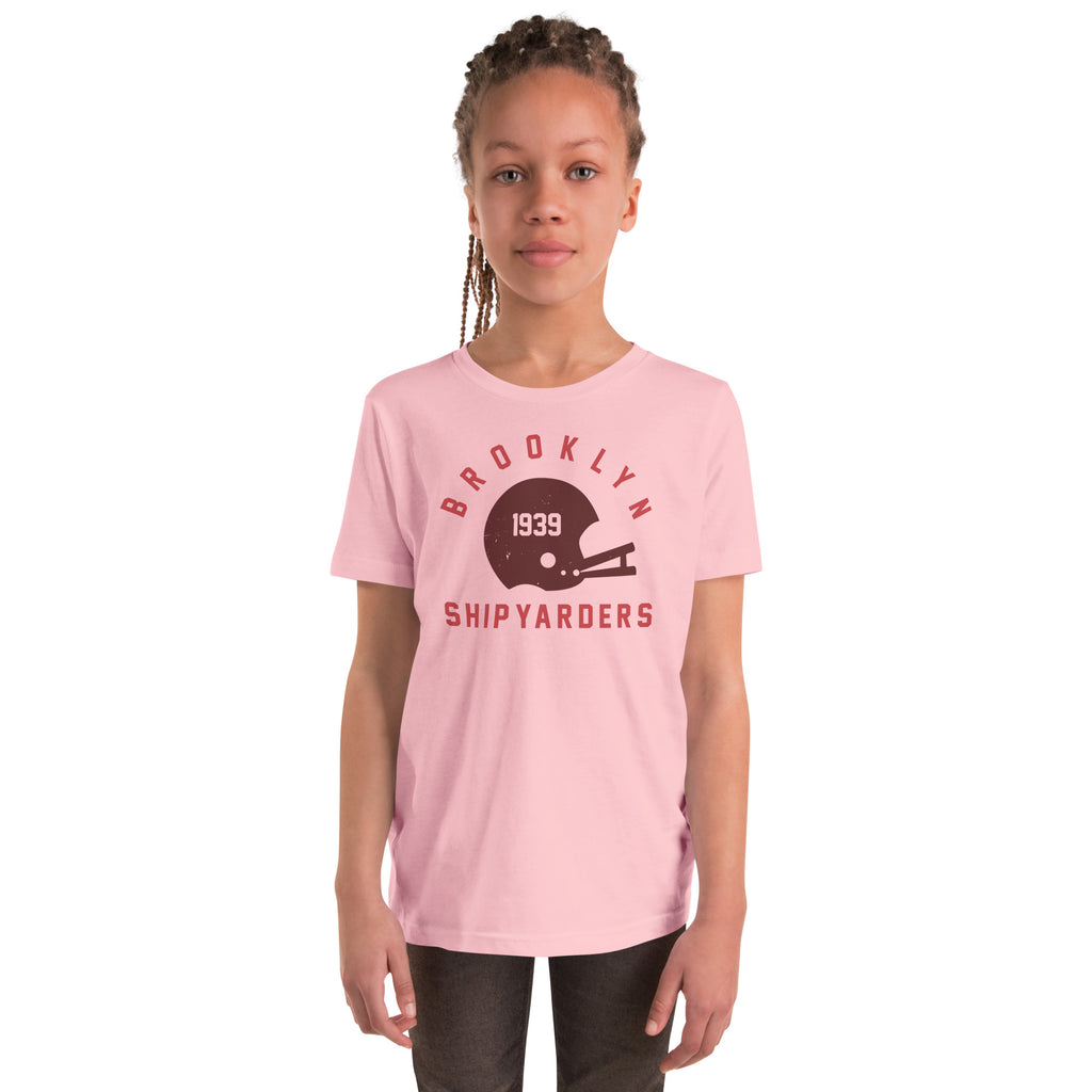 Vintage leather football helmet with "Brooklyn Shipyarders 1939", printed on a SodaPop Cool kids t-shirt.